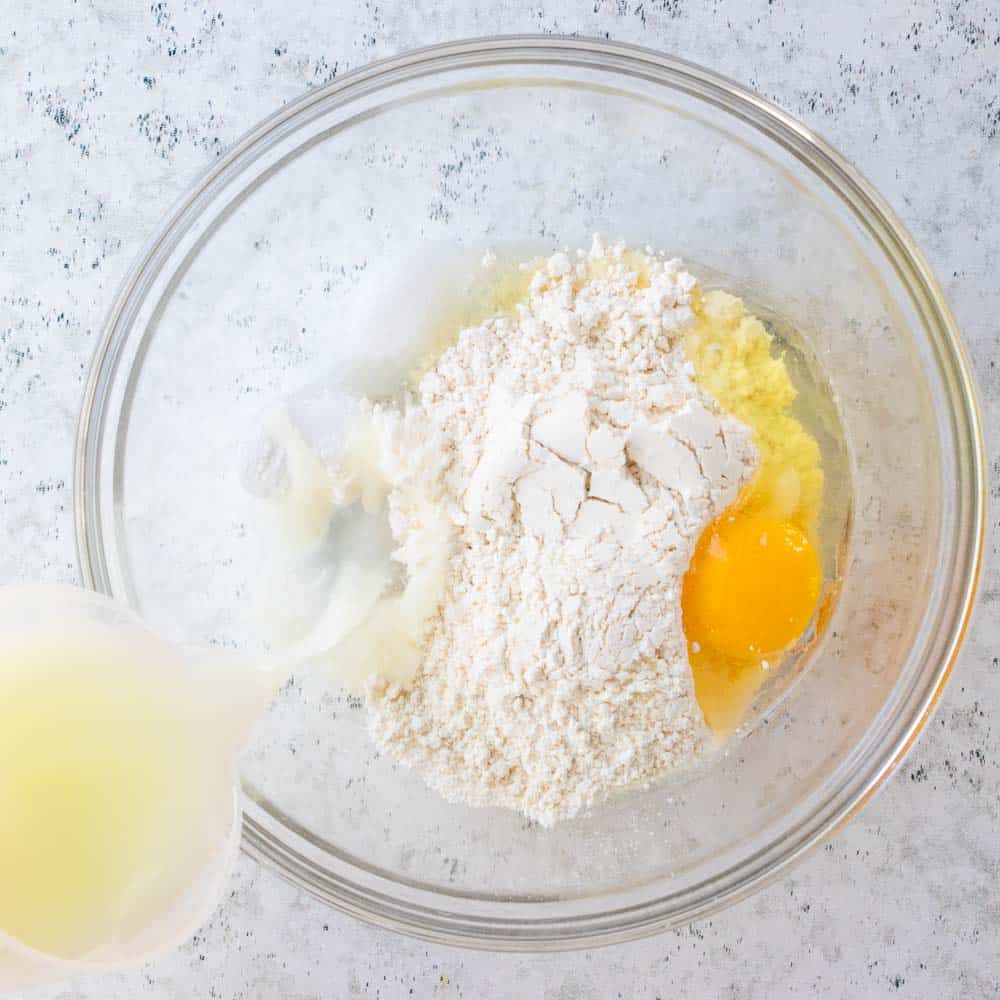 buttermilk poured into bowl with gluten free flour and egg.