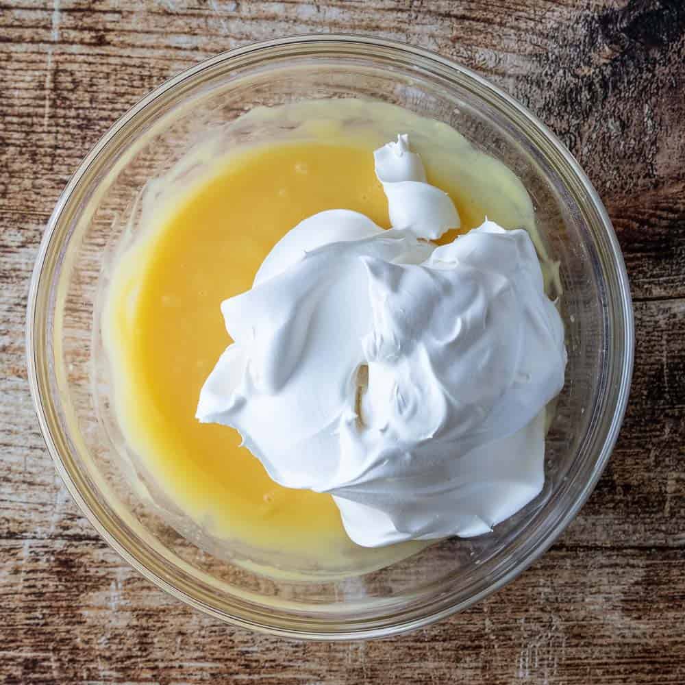 vanilla pudding and cool whip in mixing bowl