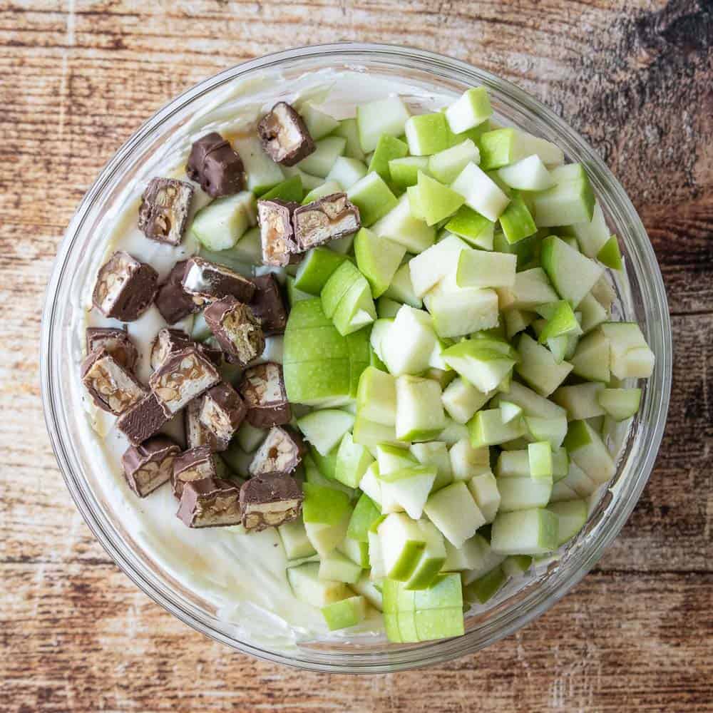 diced green apples and snickers bars in mixing bowl