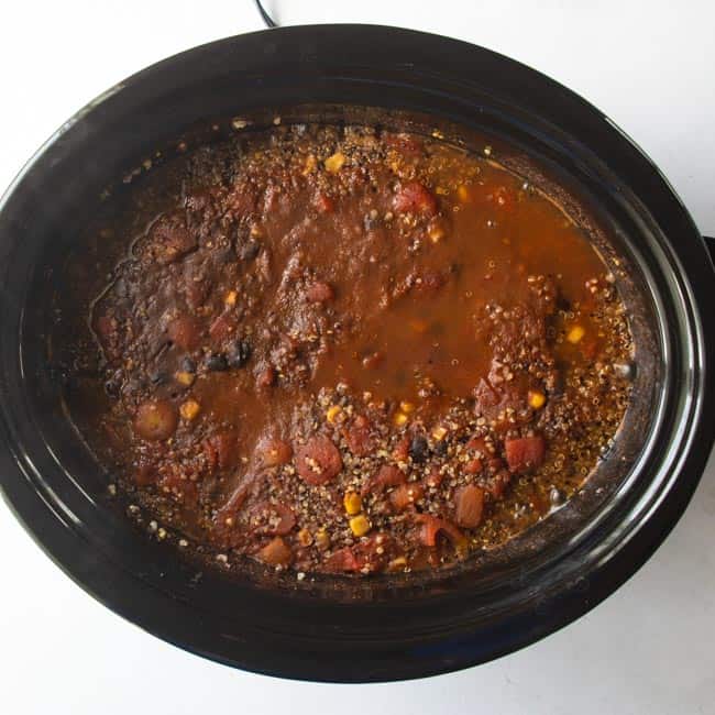 canned tomatoes, quinoa, corn and beans in slow cooker