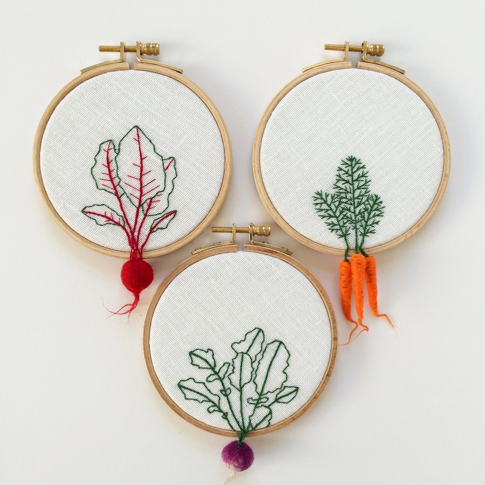 Appetising embroidery art that has crafted vegetables dangling from the