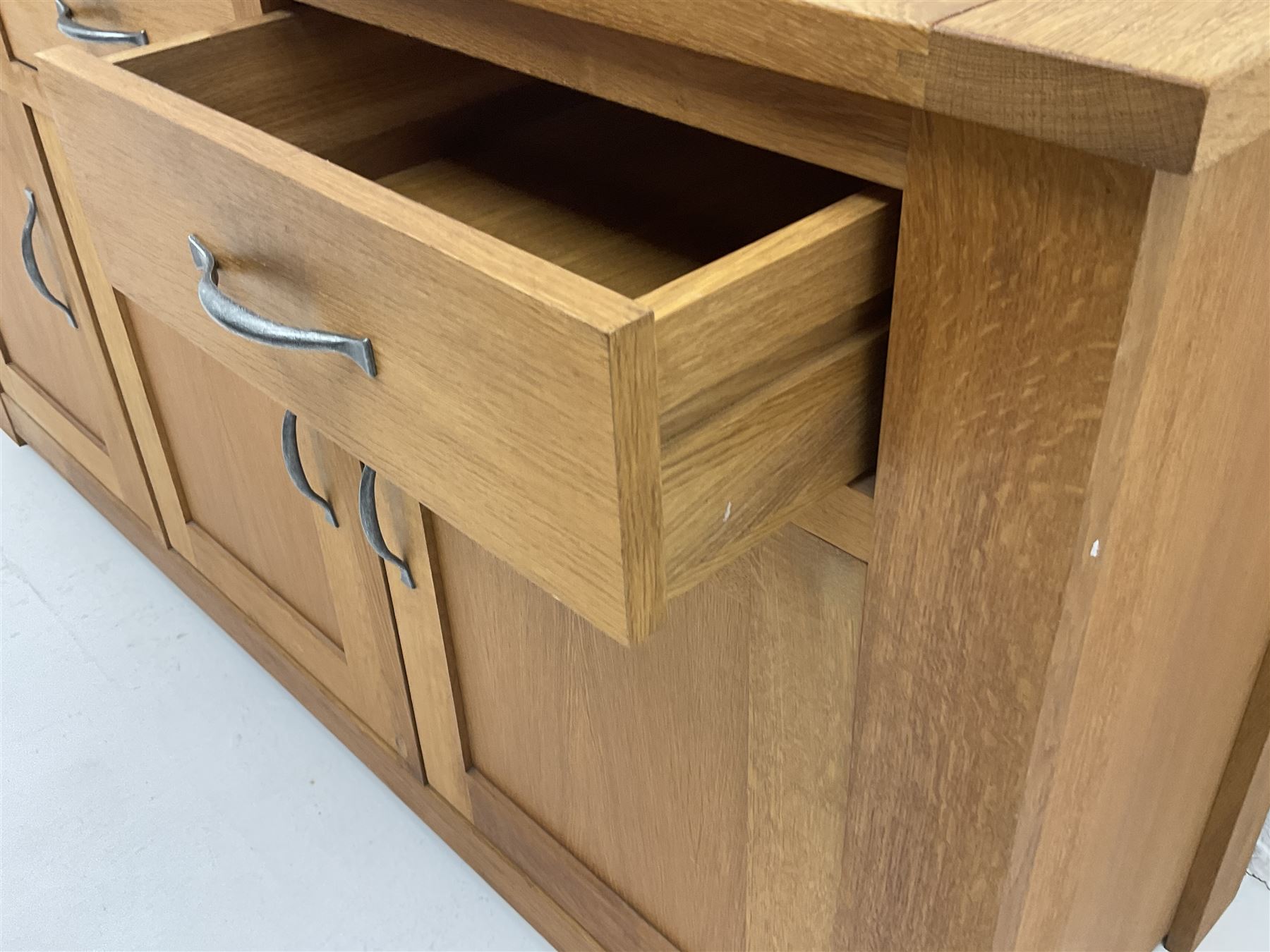 Light oak sideboard, three drawers above three cupboards enclosing