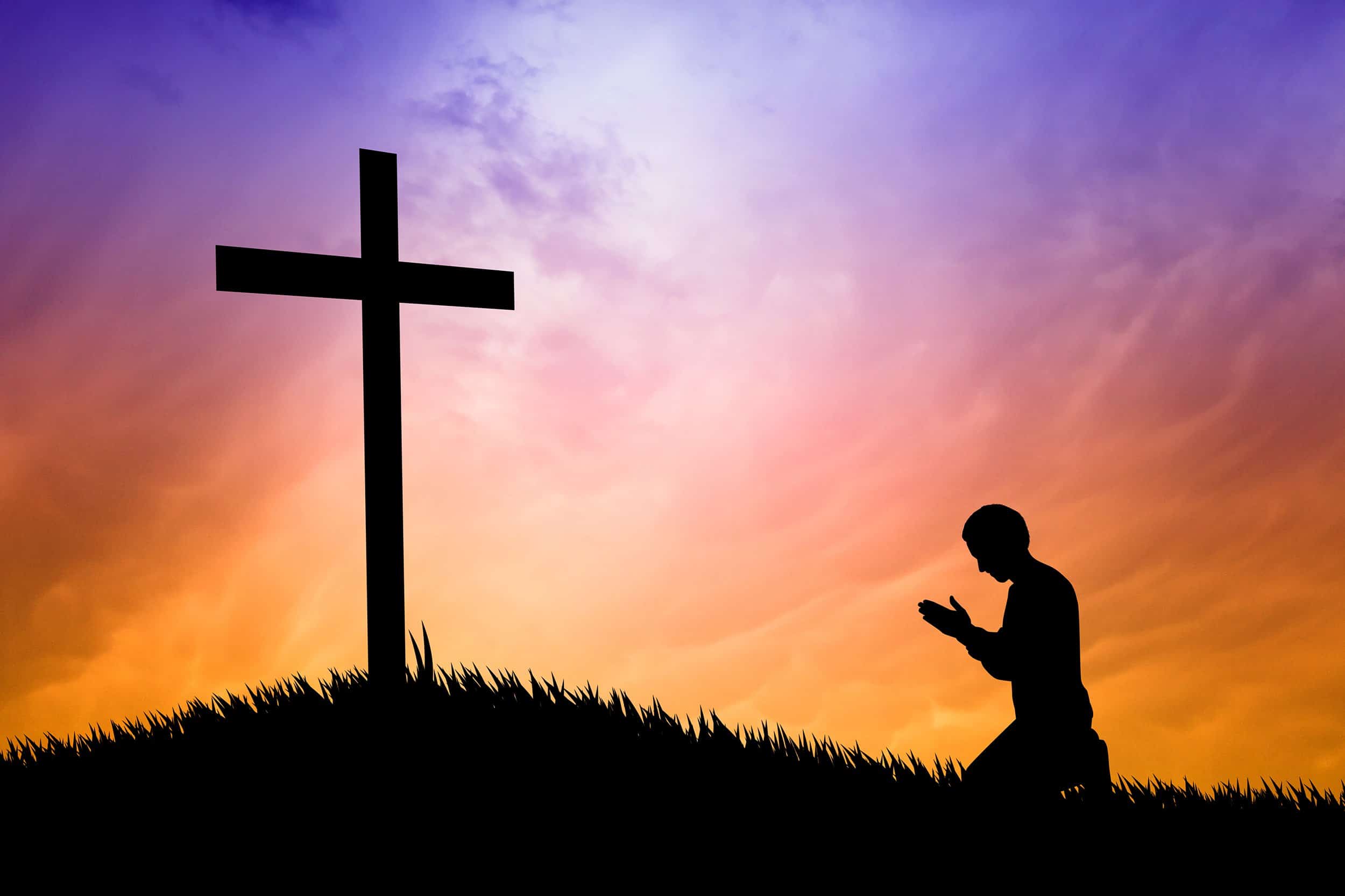 illustration of a man praying under the cross Divine Creative Love
