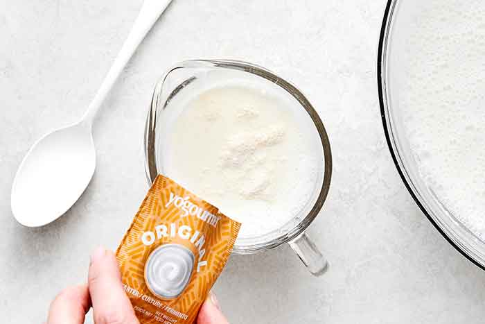 Step two of homemade yogurt: Add the yogurt starter.