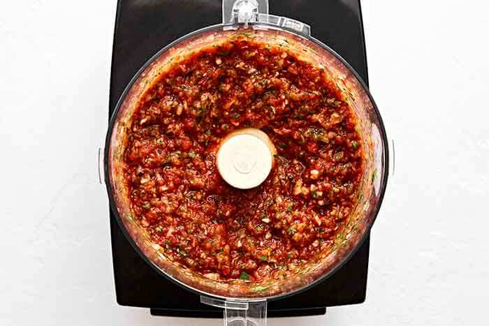 Blending salsa in a food processor.