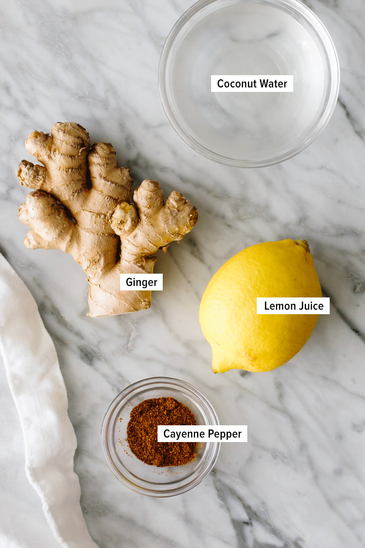 The ingredients to make ginger shots on a countertop.