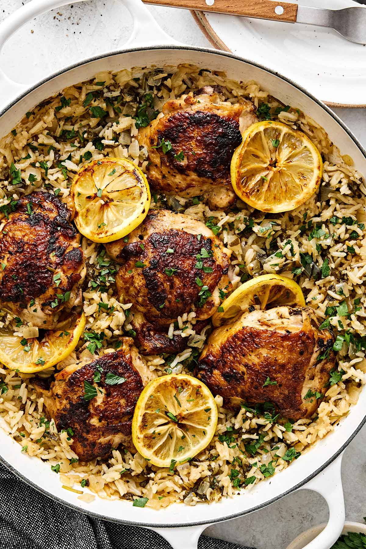 This chicken and rice is an easy, one-pan weeknight dinner I can always depend on. Mediterranean chicken thighs mixed with herby rice! One pan chicken and rice with Mediterranean flavors.