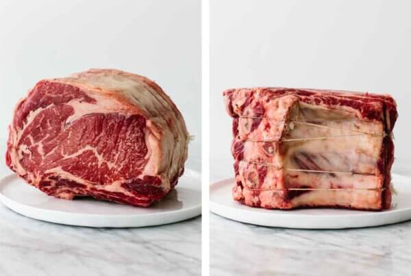 Raw prime rib on a plate on a table.