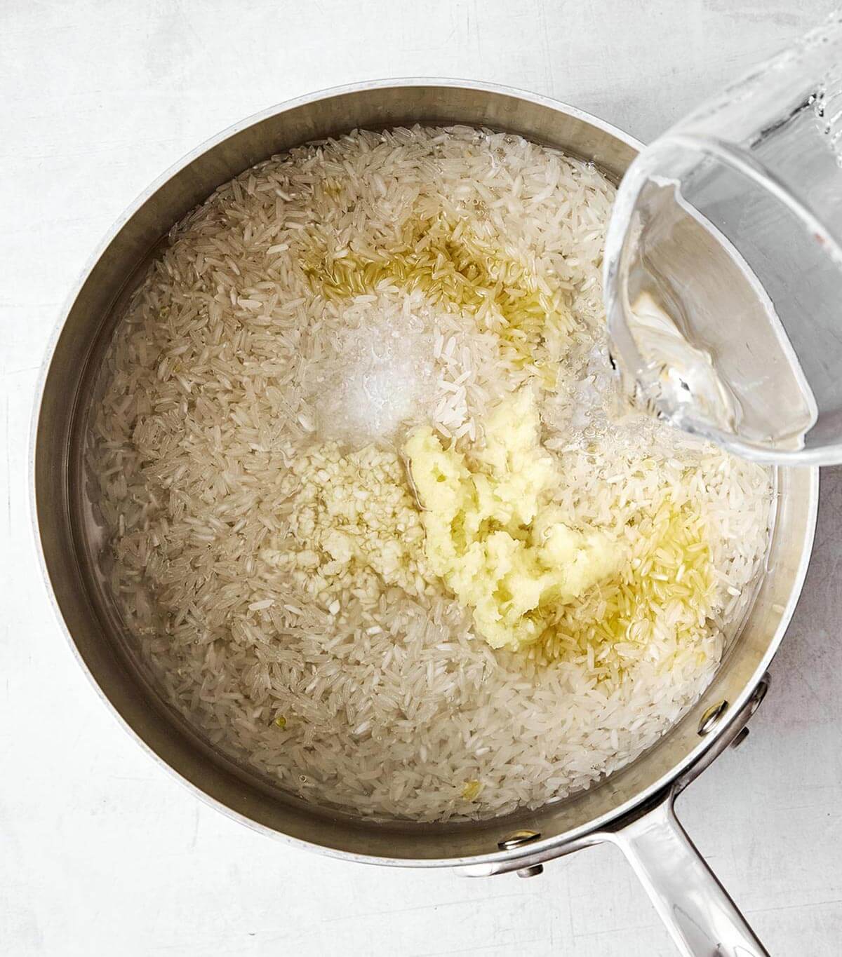 Cooking ginger rice in pot.