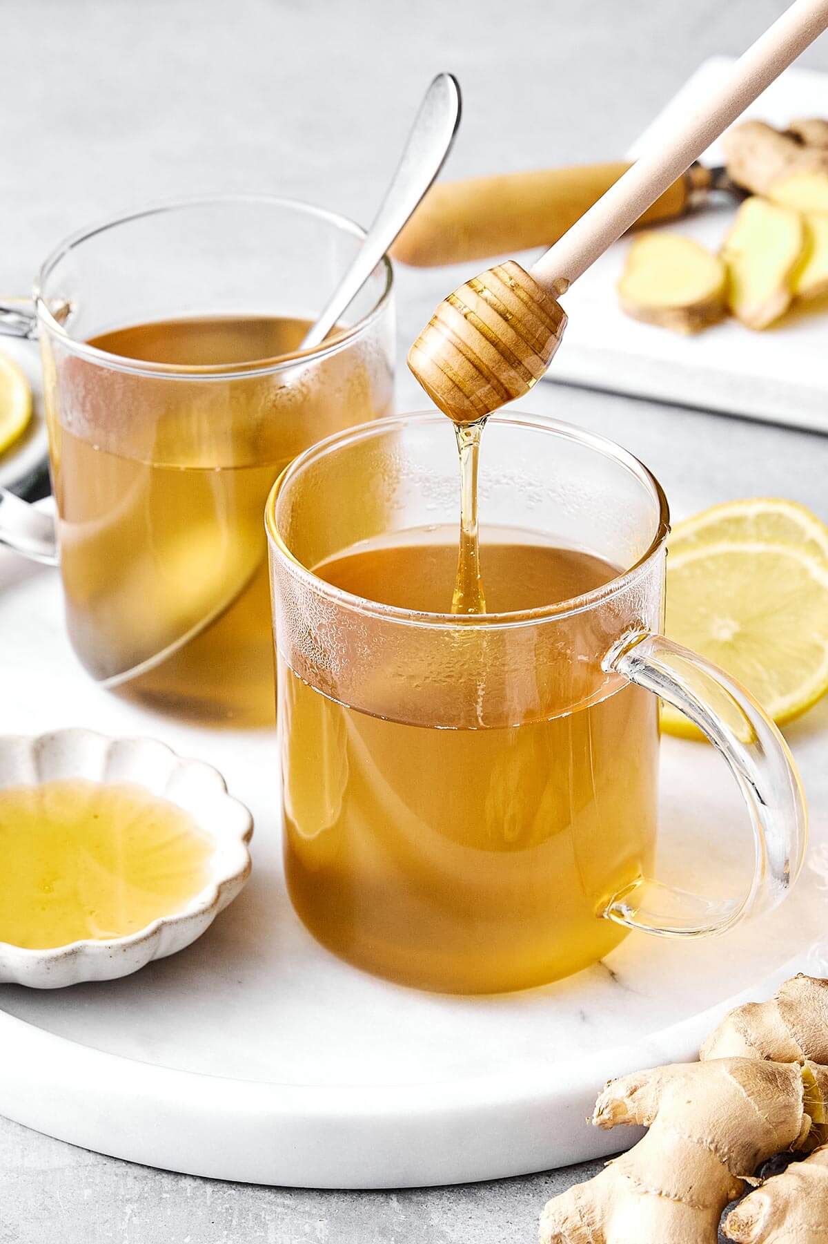 Adding honey to ginger tea.