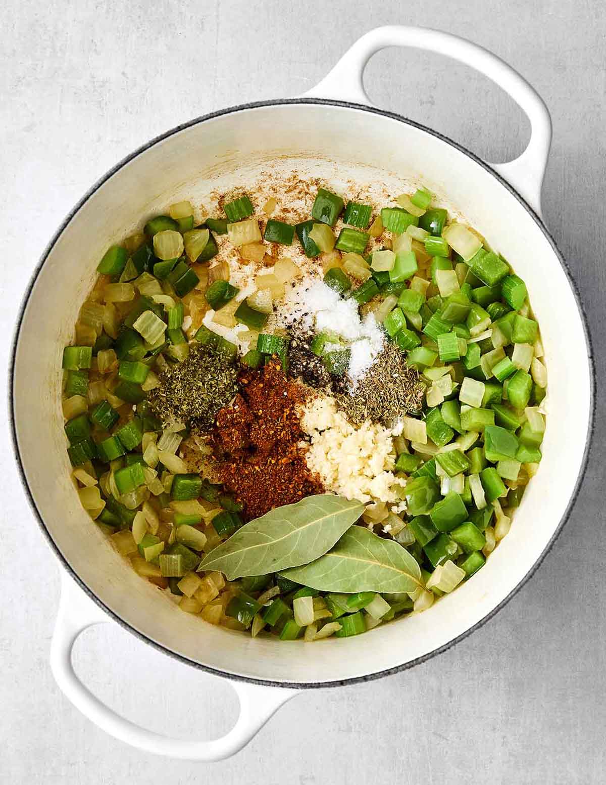 This red beans and rice with sausage is rich with Cajun flavors and perfect for a comforting family dinner. Plus, it's super easy in one pot! Step three of red beans and rice: add aromatics and veggies.