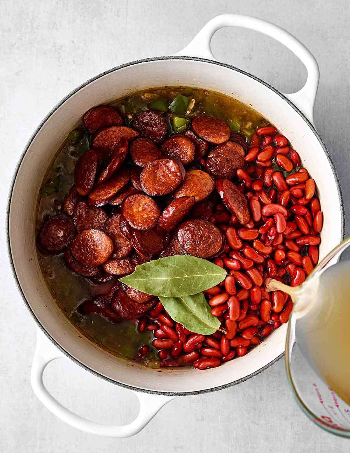 This red beans and rice with sausage is rich with Cajun flavors and perfect for a comforting family dinner. Plus, it's super easy in one pot! Step four of red beans and rice: add sausage and beans.