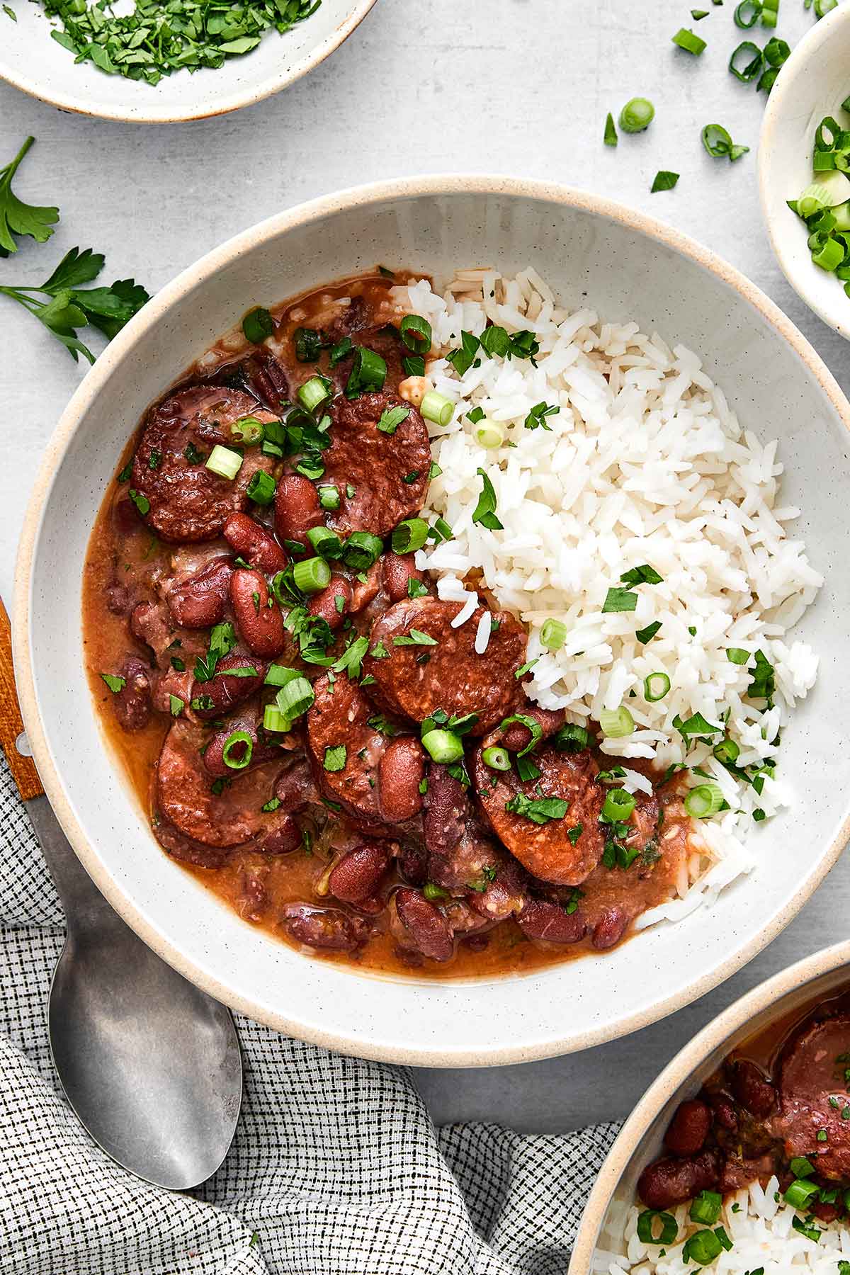 This red beans and rice with sausage is rich with Cajun flavors and perfect for a comforting family dinner. Plus, it's super easy in one pot! Red beans and rice.