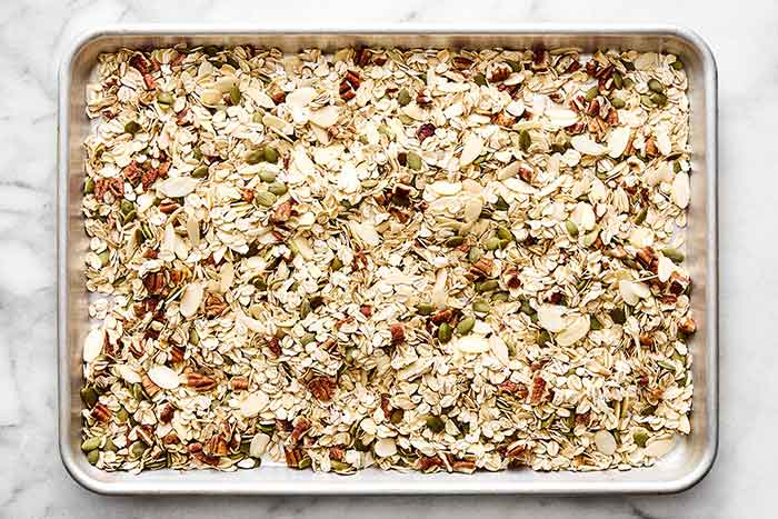 Toasting muesli ingredients on a sheet pan.