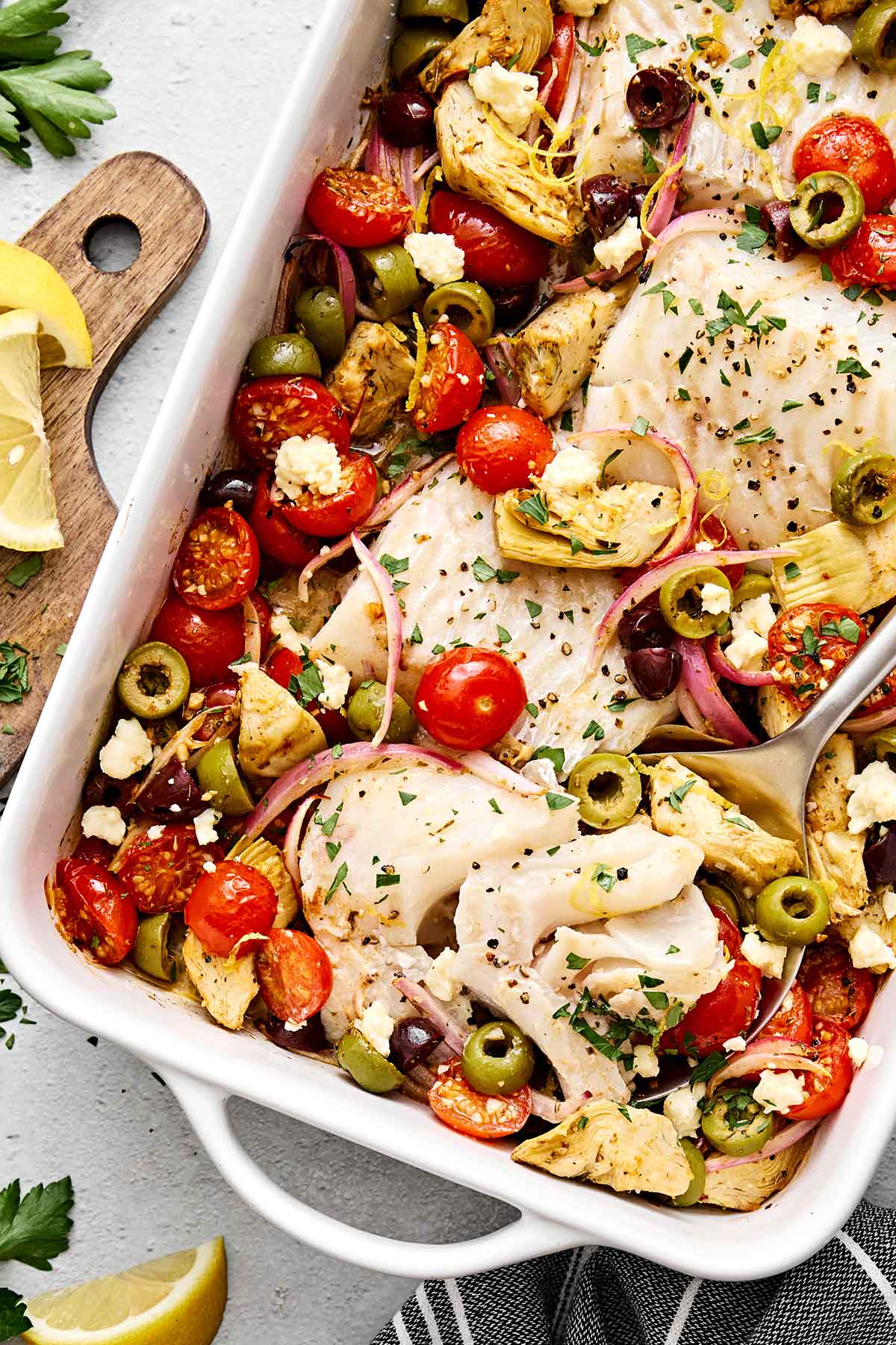 This Greek baked cod is the perfect all-in-one Mediterranean dinner! It's healthy, easy, and delicious! Greek baked cod with vegetables.