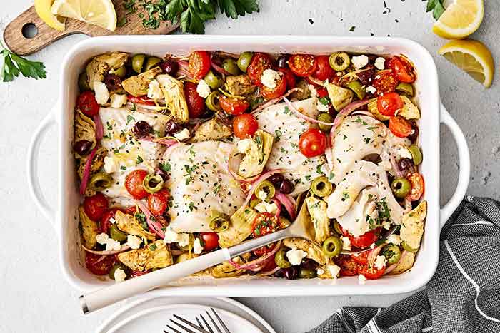 Greek baked cod in a casserole pan.