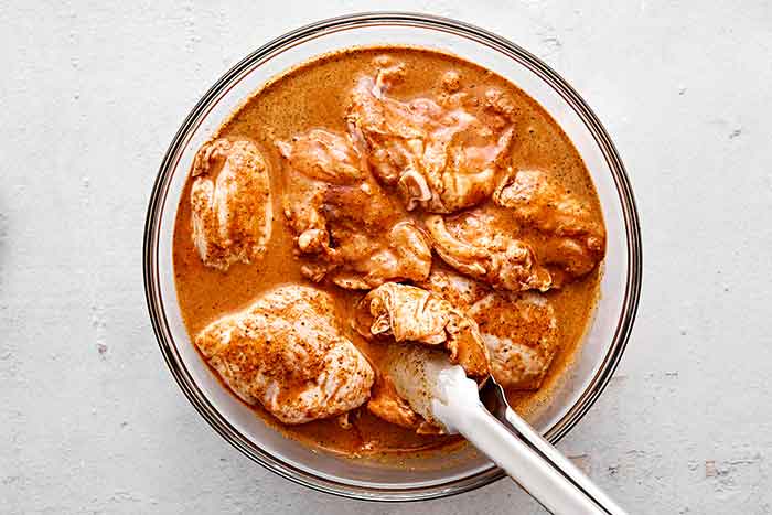 Marinating chicken in pollo asado marinade.