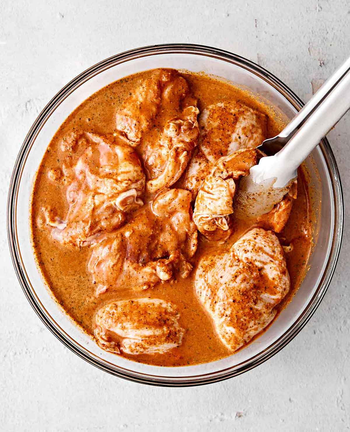 With a bold citrus marinade and smoky char, this grilled pollo asado (chicken) is the best grilling recipe for Mexican dinner nights! Marinating chicken in pollo asado marinade.