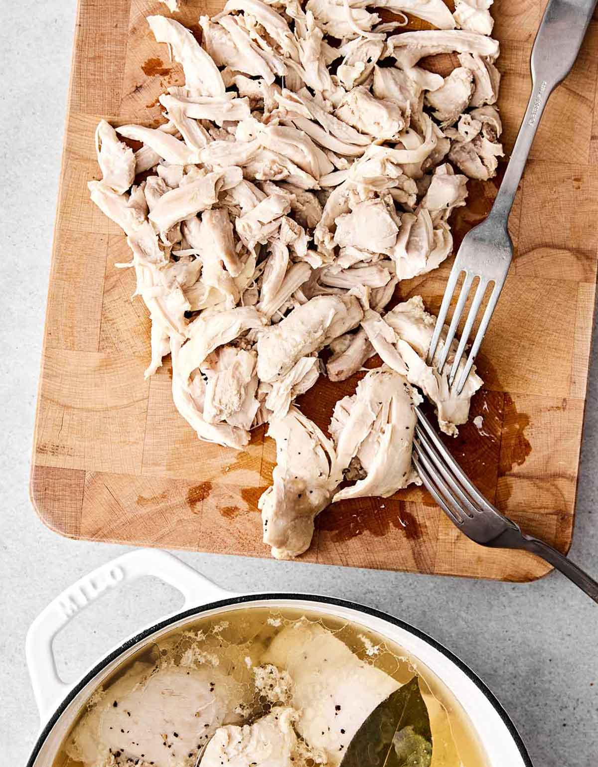 Shredded chicken on a board for chicken tinga.