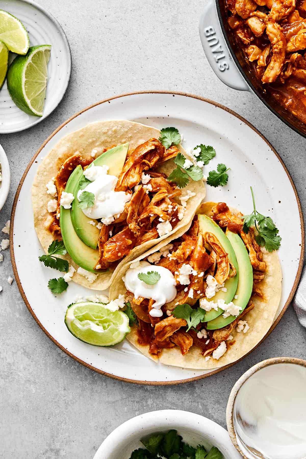 You'll eat this Mexican chicken tinga on repeat! It's made with shredded chicken, a smoky tomato-chipotle sauce, and caramelized onions. Chicken tinga tacos.