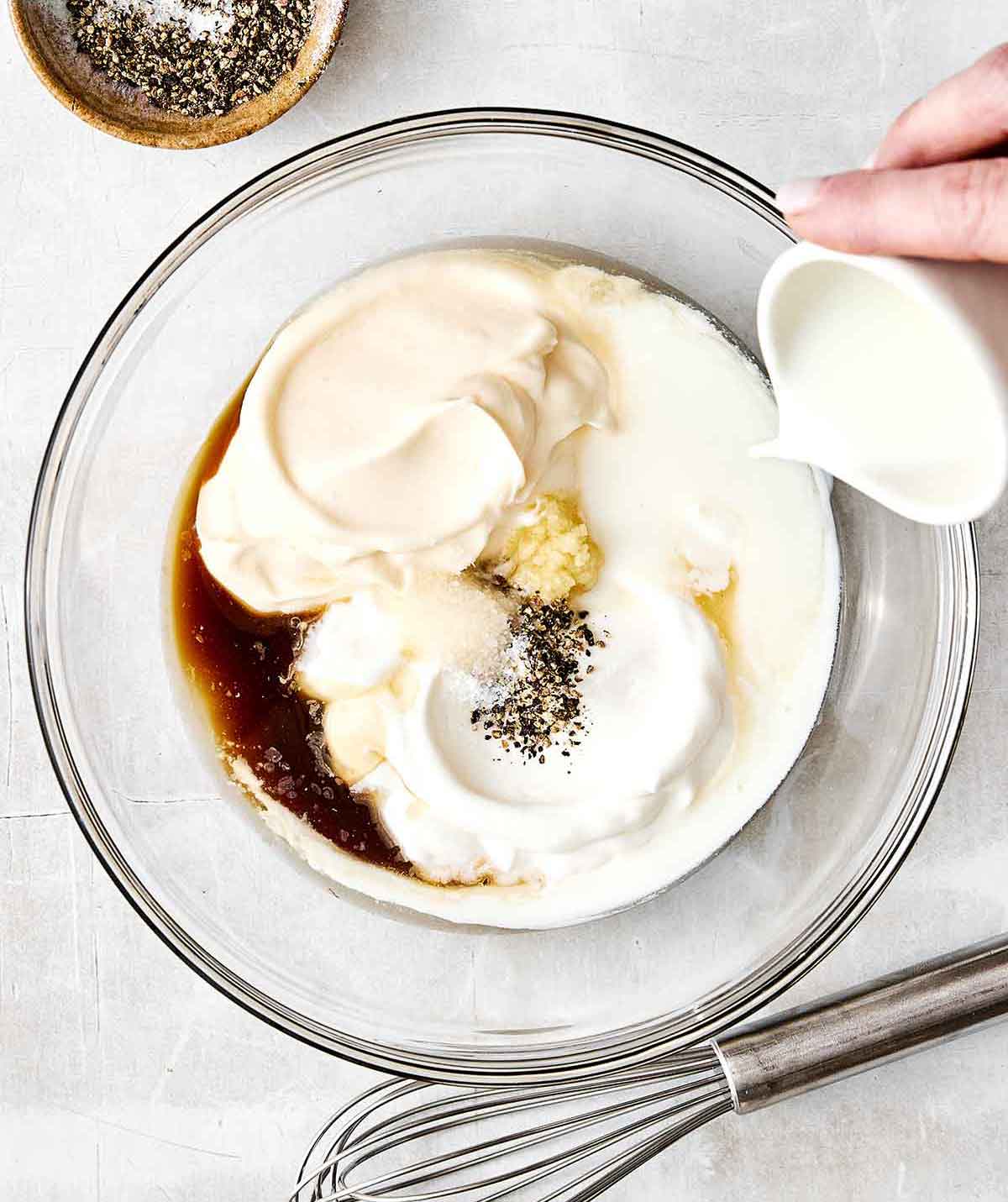 This blue cheese dressing is rich, creamy, tangy, and gives that classic steakhouse flavor perfect for a classic wedge salad. Mixing blue cheese dressing in a bowl.