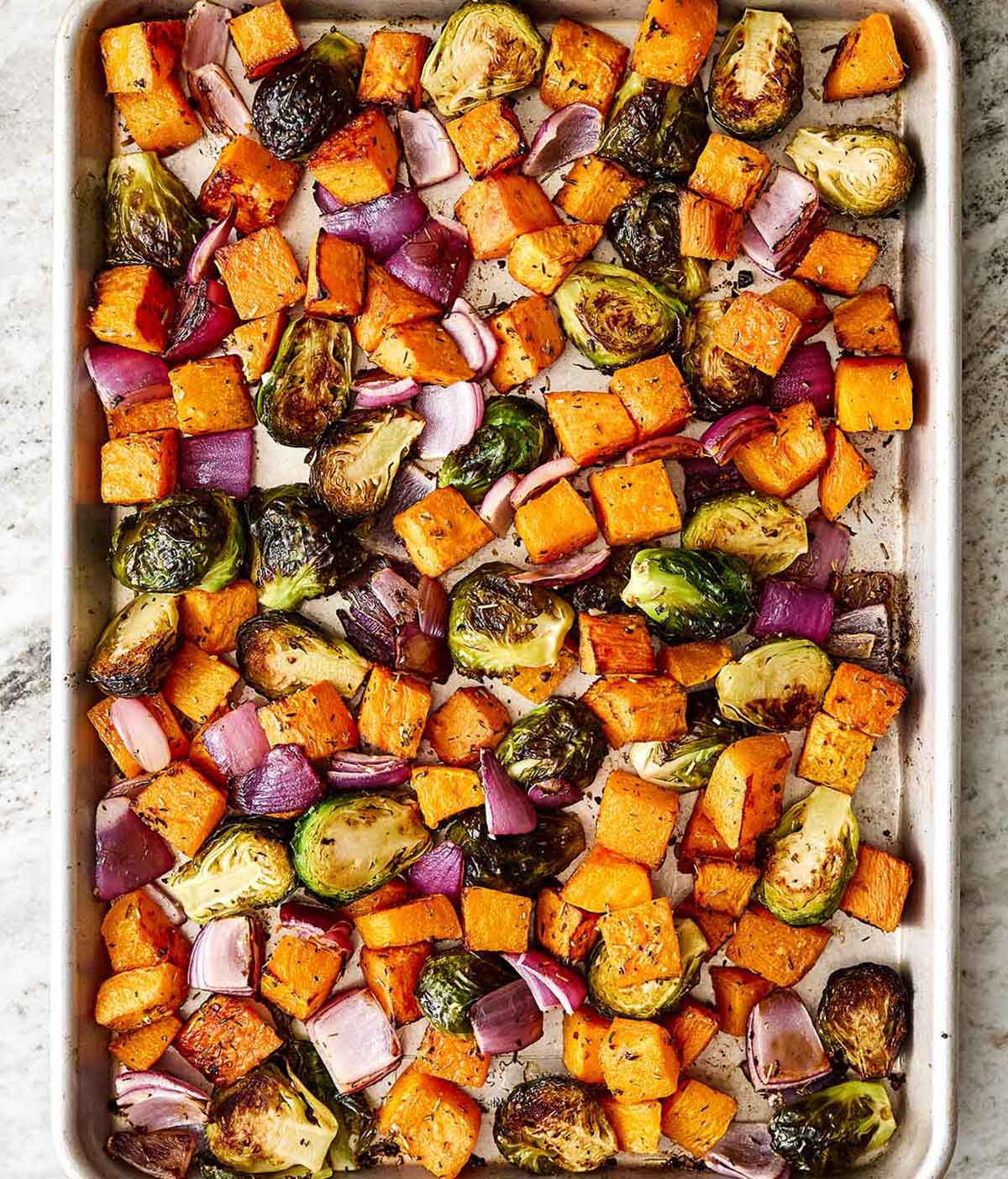 Fall roasted vegetables for the perfect dinner side dish. Roasting fall vegetables on a sheet pan.