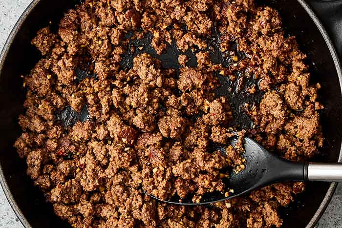 Mixing ground beef with Korean inspired sauce.