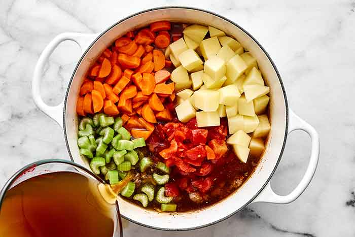 Cooking hamburger soup in a pot.