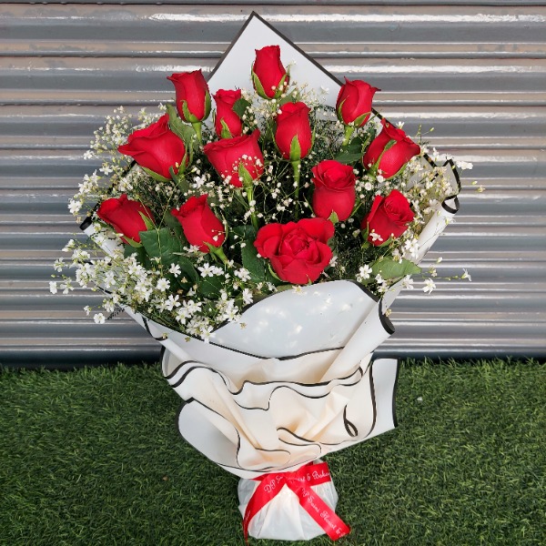 Red Rose with designer sheet packing DP Saini Florist