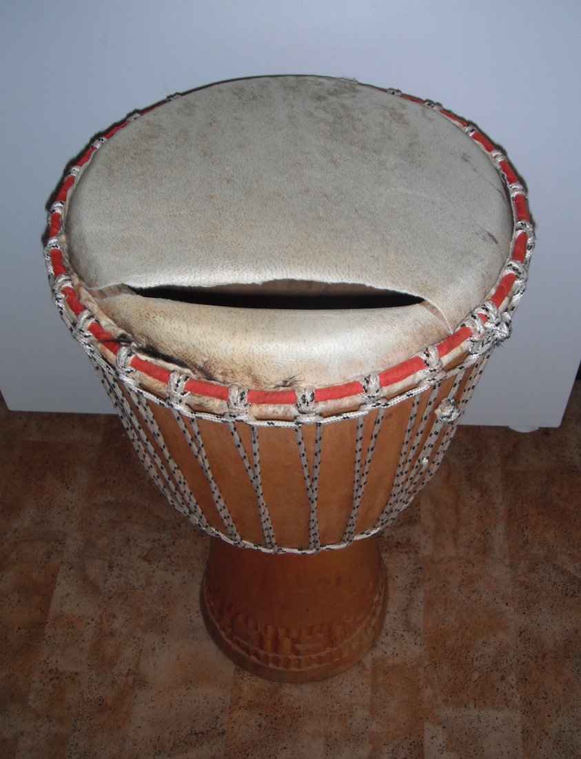 Djembe hand drum with a torn skin.