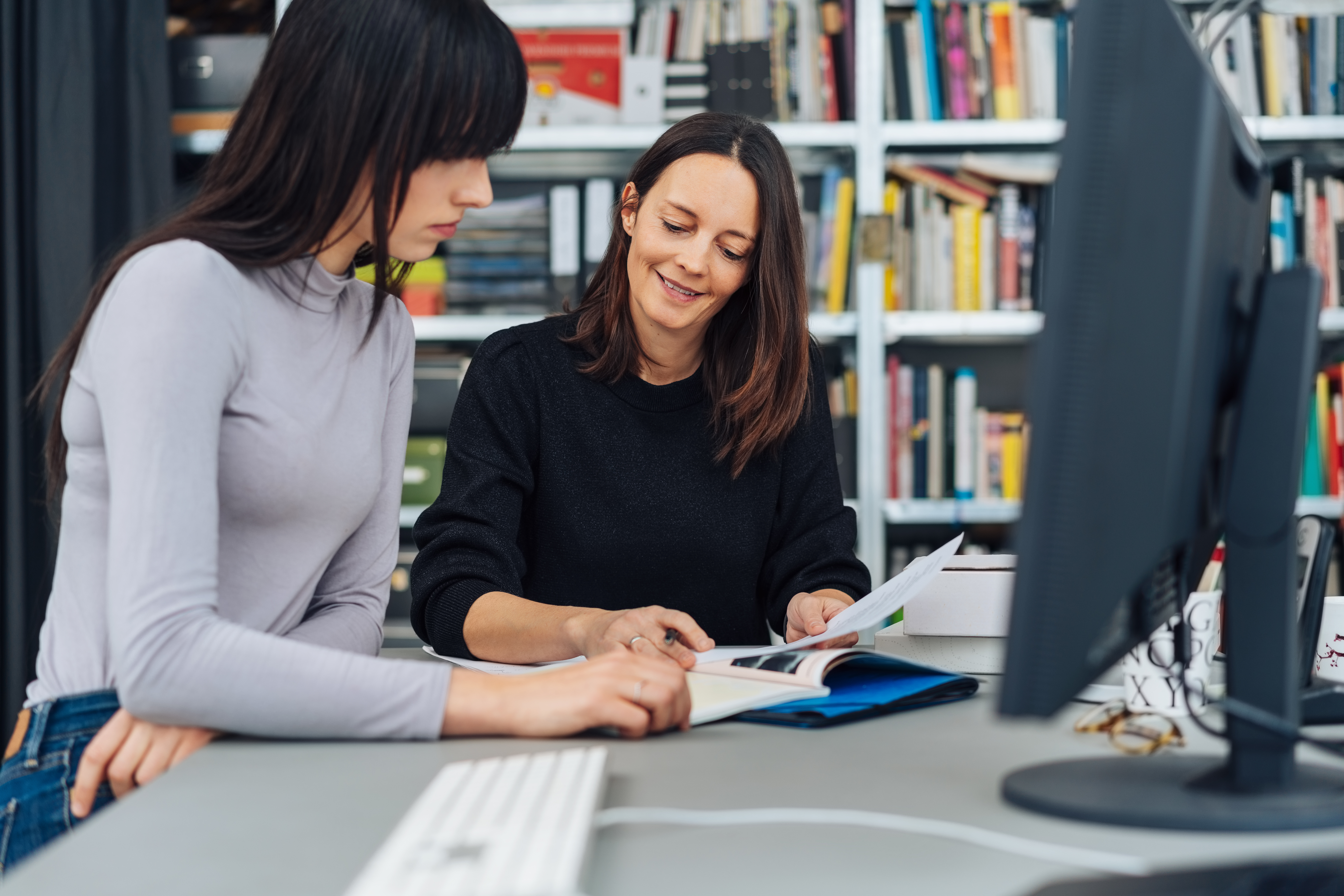 Smiling manageress helping a coworker easleyLAW