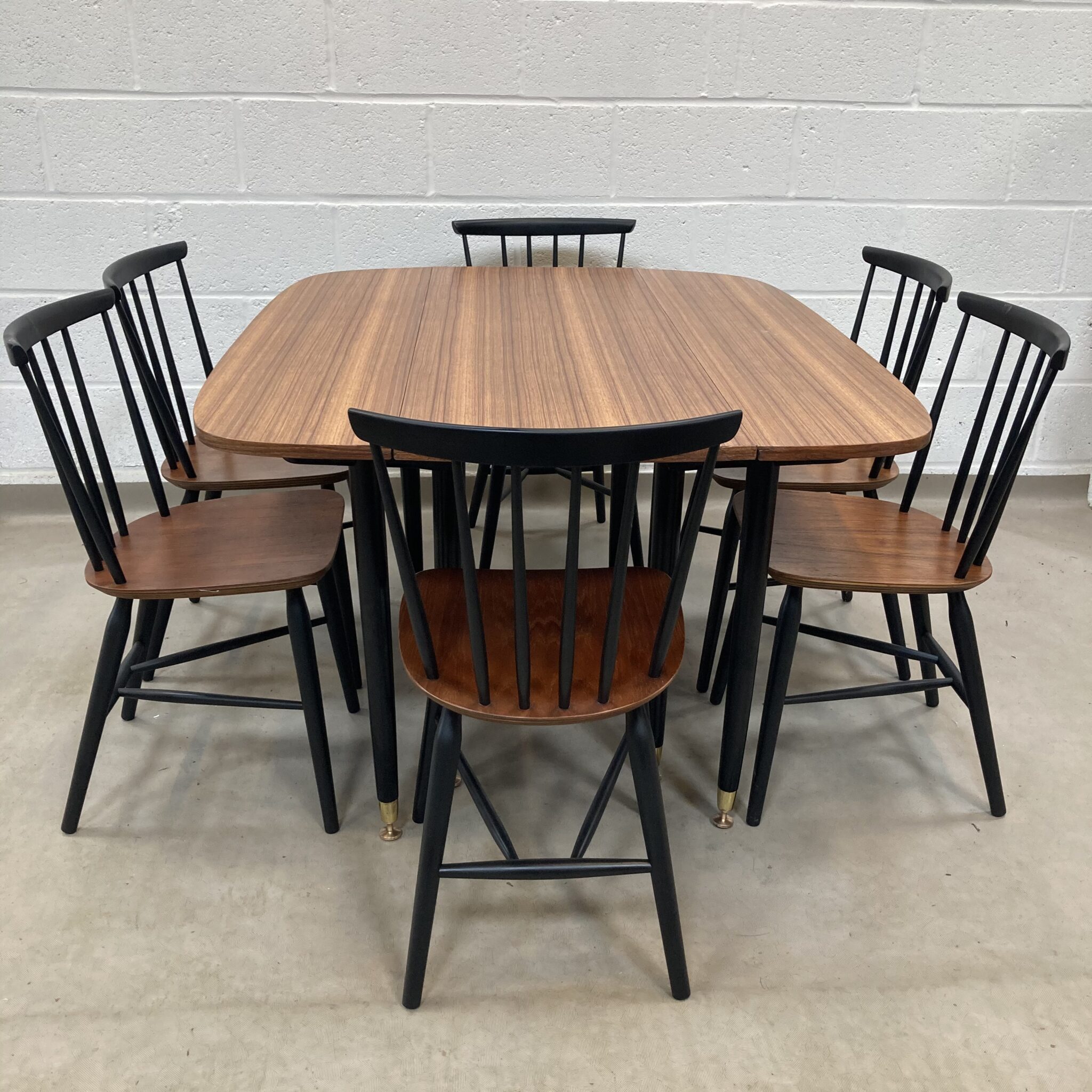A Gplan librenza Walnut and black gate leg dining table Elephant