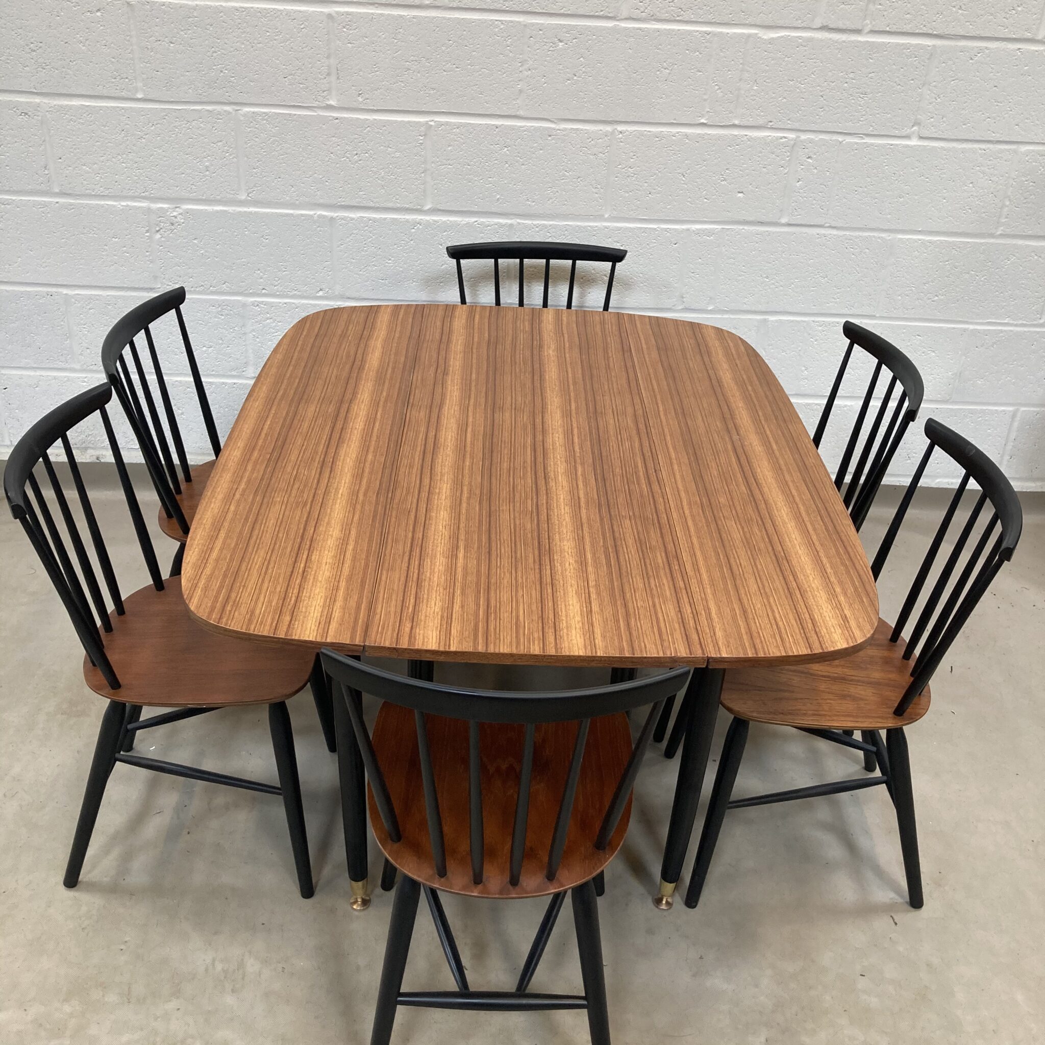 A Gplan librenza Walnut and black gate leg dining table Elephant