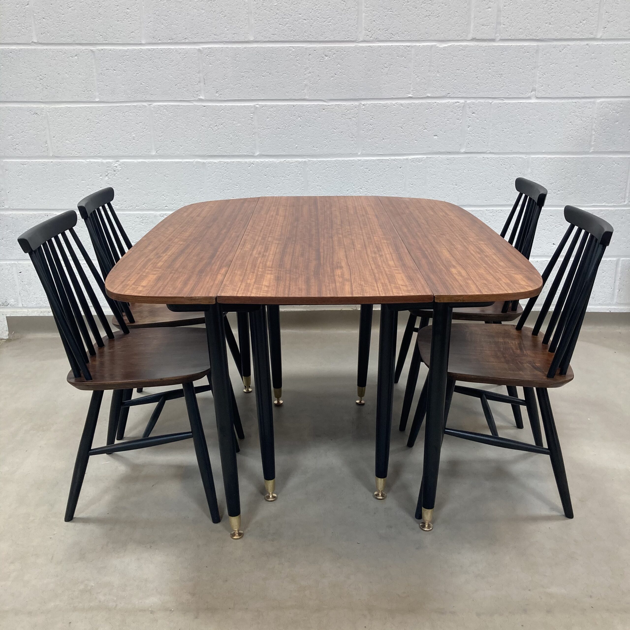 A Gplan librenza Walnut and black gate leg dining table Elephant