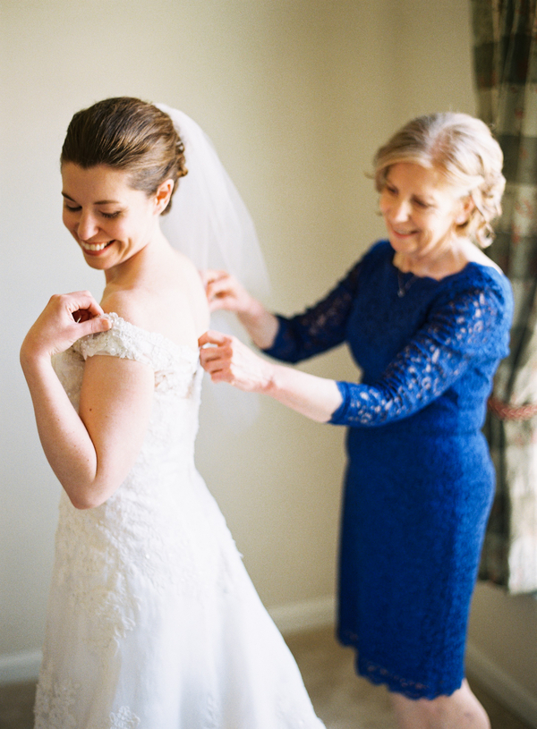 Bride Getting Dressed in Gown Elizabeth Anne Designs The Wedding Blog