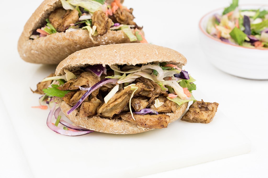 Vegan jerk chicken, stuffed whole grain pita with healthy salad