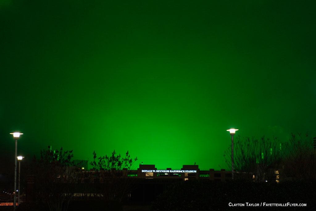 Lights at Razorback Stadium cast eerie green glow over Fayetteville