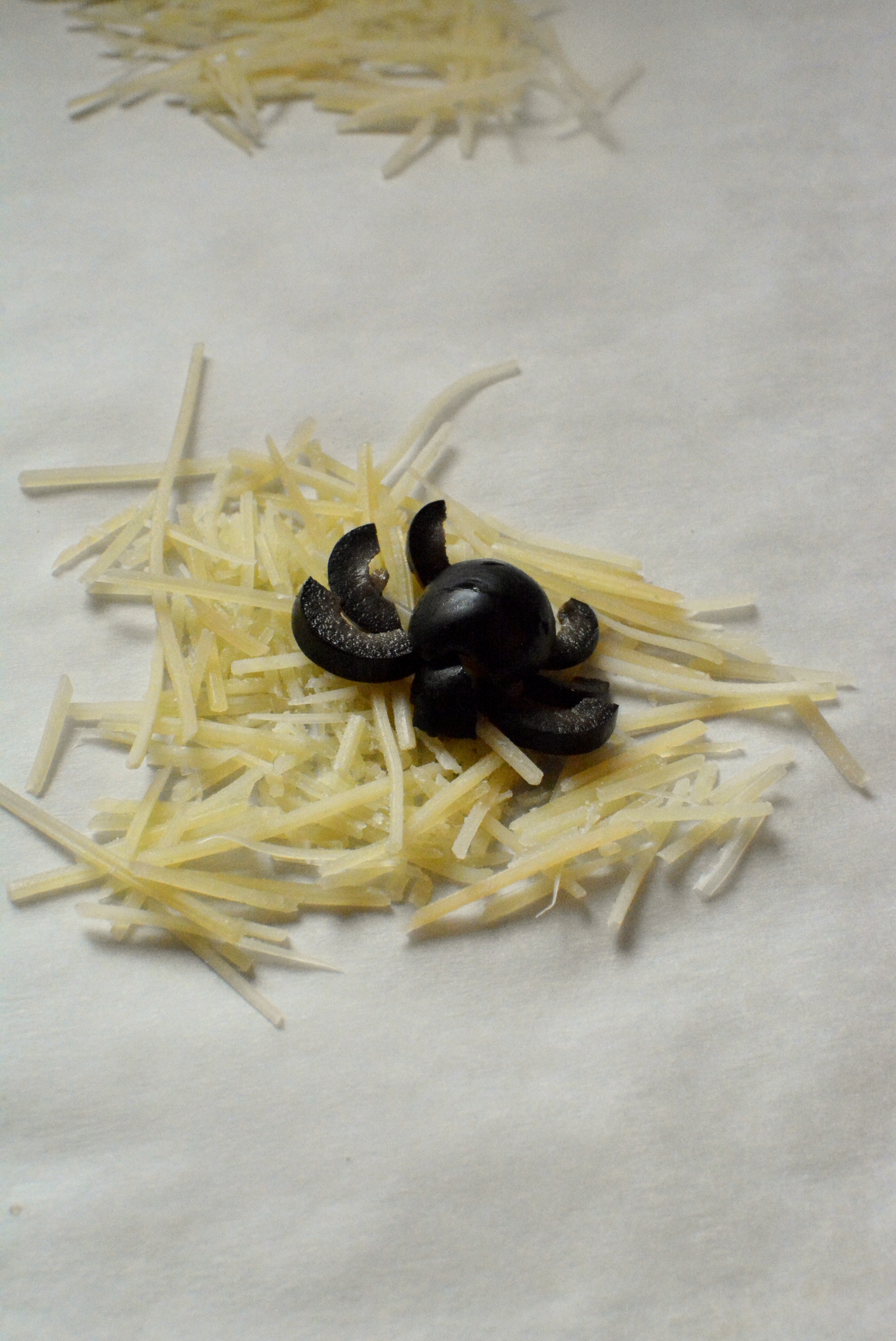 Parmesan Cheese Crisps with Black Olive Spiders