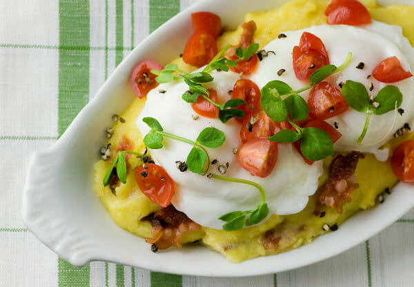 poached eggs with bacon polenta and cherry tomatoes