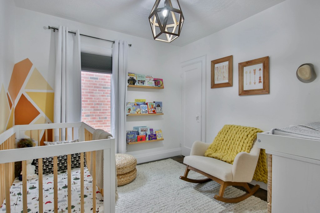 Child's nursery with an orange feature wall 