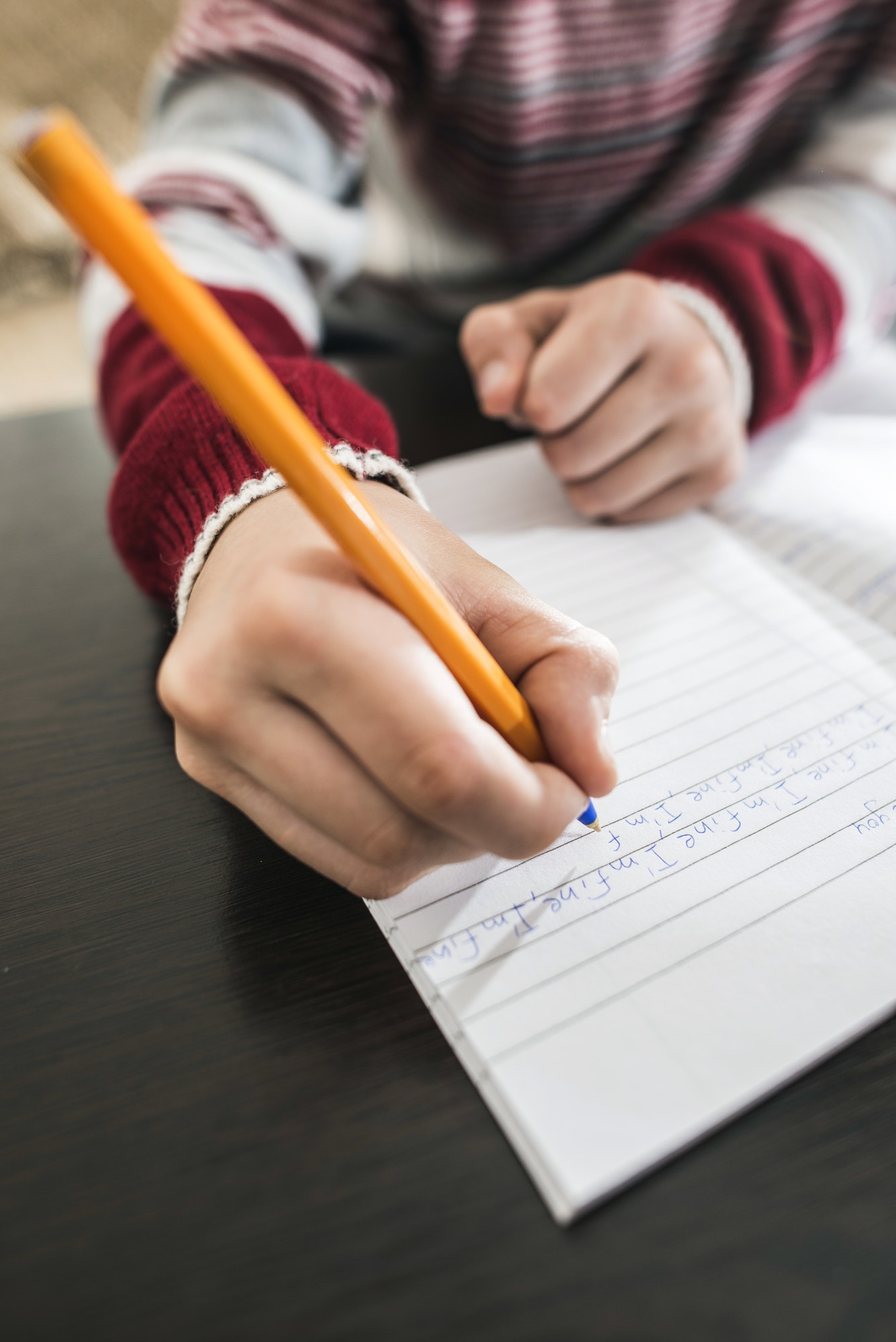 Child write in a notebook.