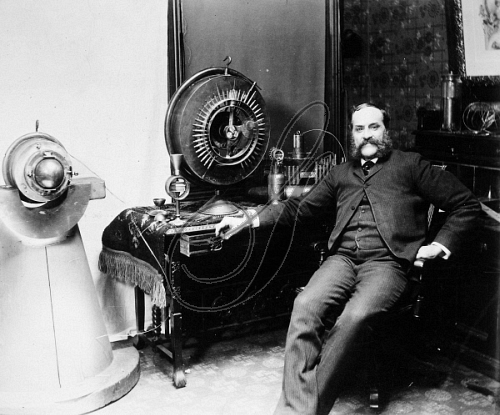 John Ernst Worrell Keely poses with his nonfunctional "Keely Engine"