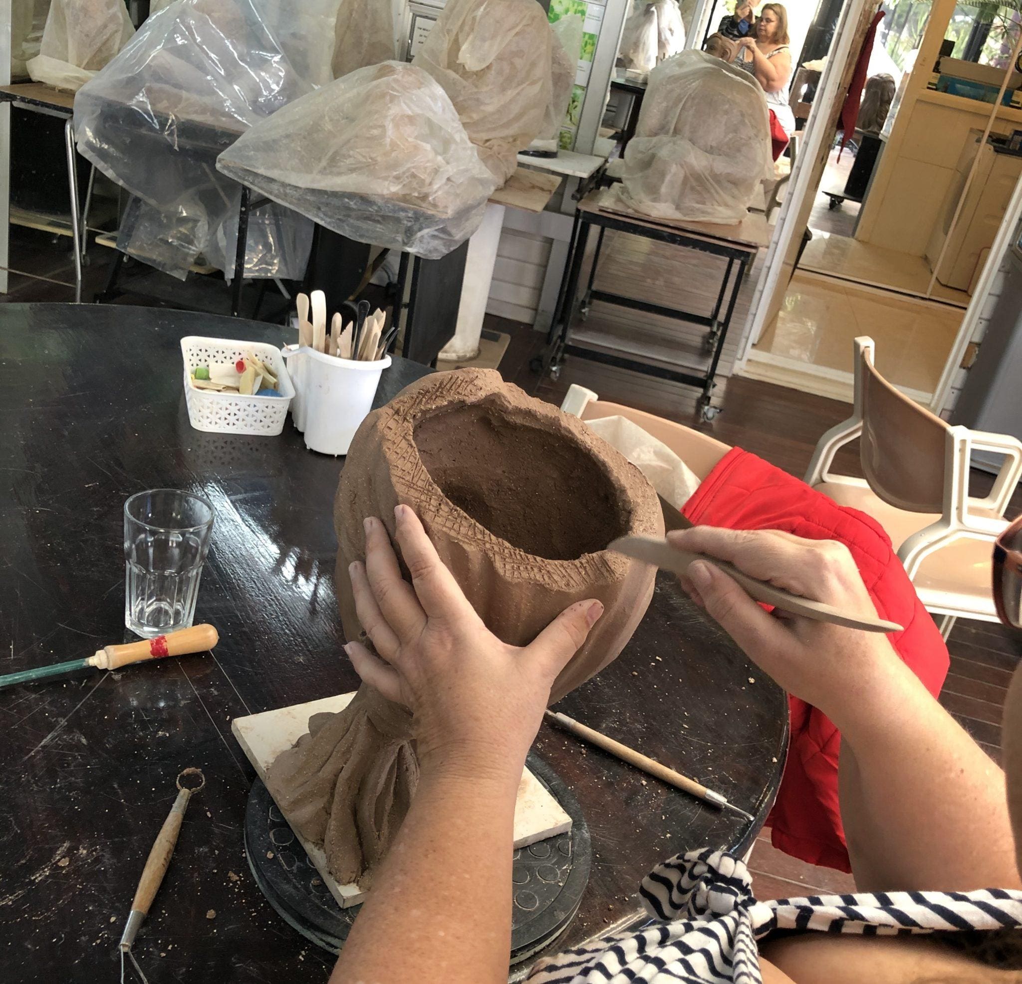 Social distancing during the clay art sculpturing class Art
