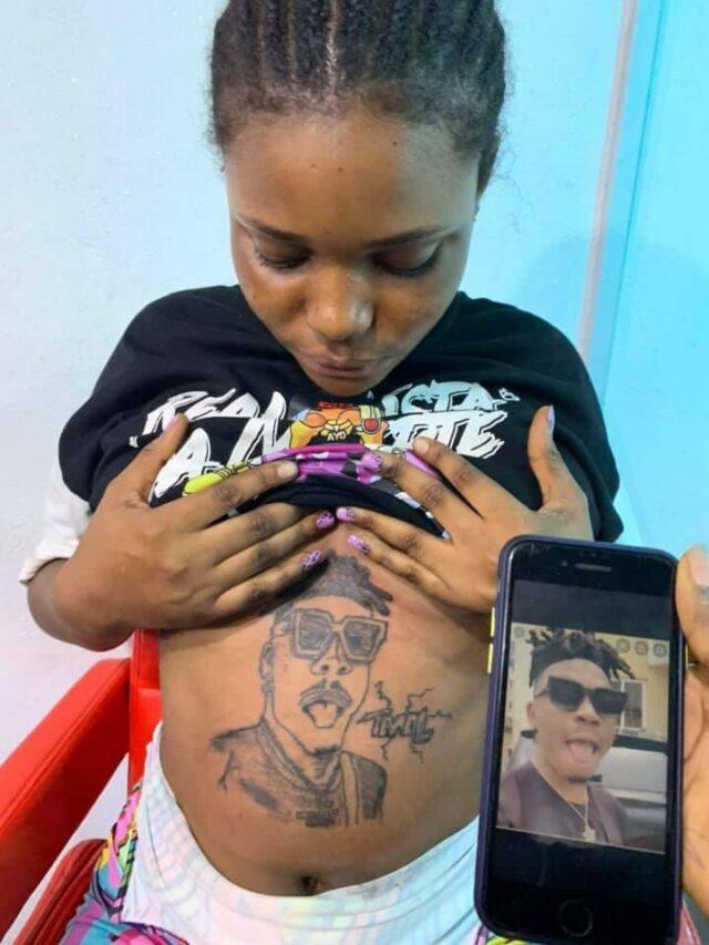 Reactions as pregnant lady tattoos Mayorkun's face on her