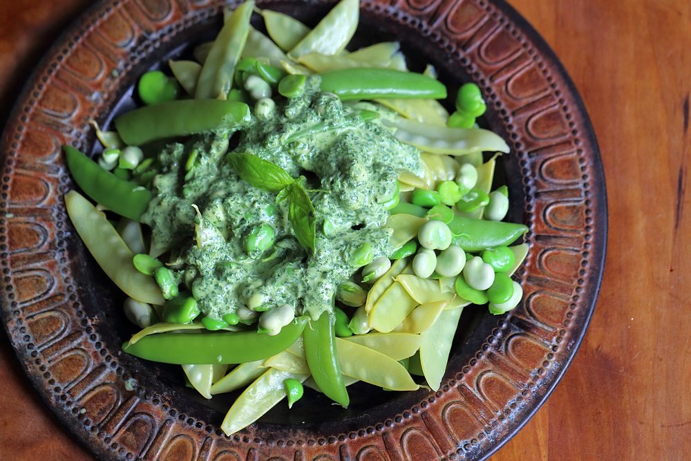 Broad beans and peas salad with basil dressing grown to cook
