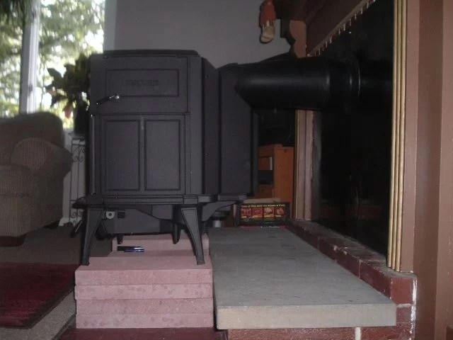 Rear vent wood stove through masonry fireplace Hearth