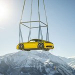 Porsche 911 dropped off by helicopter at a spectacular alpine resort