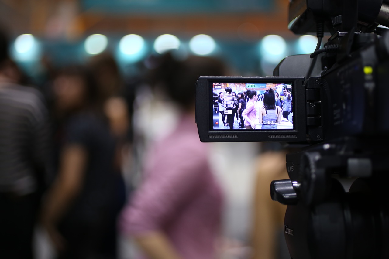 A multimedia producer's day includes a variety of tasks, including video shooting.