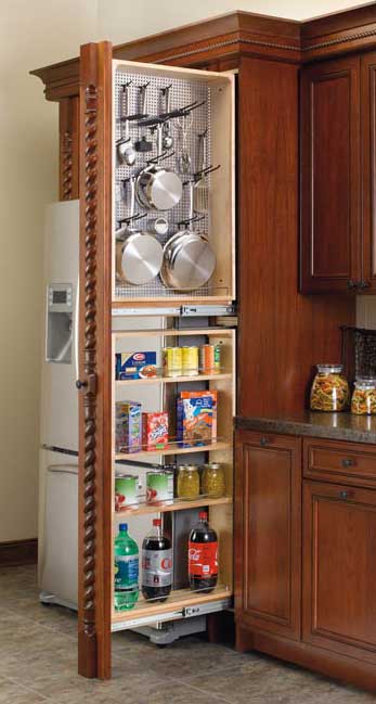 Kitchen sink with stainless steel countertop, wood cabinets, and deep drawers for storage. Kitchen Cabinet Accessories | Amish Made Heirlooms