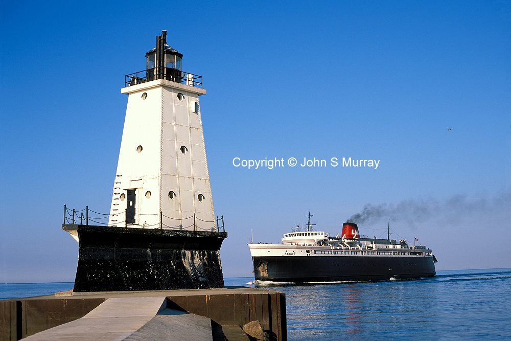 Lake Michigan Car Ferry SS Badger passes Ludington Michigan Lighthouse